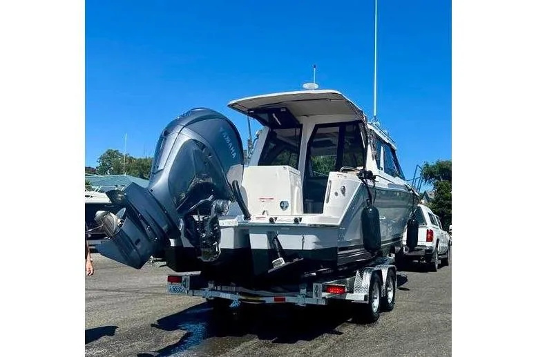  Yacht Photos Pics 2025 Cutwater C-248 Coupe boat on trailer, featuring dual outboard engines.