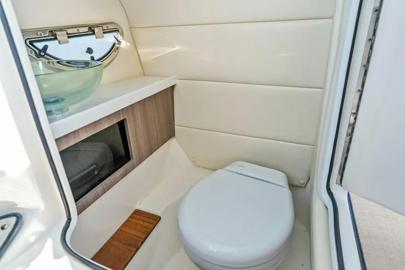  Yacht Photos Pics 2023 Regal 29 OBX boat bathroom with modern fixtures and compact design.