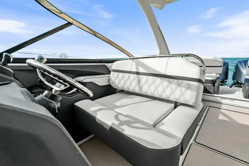 Yacht Photos Pics 2023 Regal 29 OBX boat interior with luxurious seating and modern steering wheel.