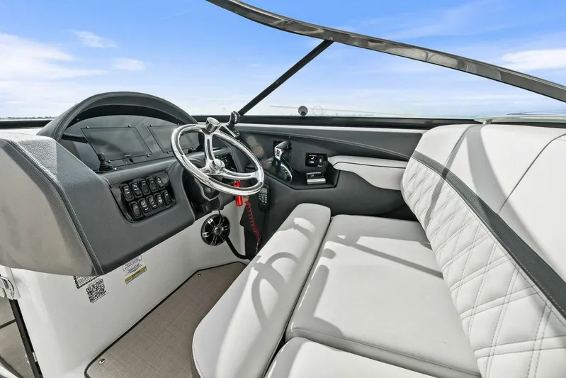  Yacht Photos Pics 2023 Regal 29 OBX boat interior with steering wheel and seating.