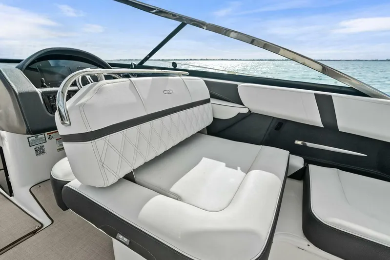  Yacht Photos Pics 2023 Regal 29 OBX boat interior with luxurious white seating and sleek dashboard design.