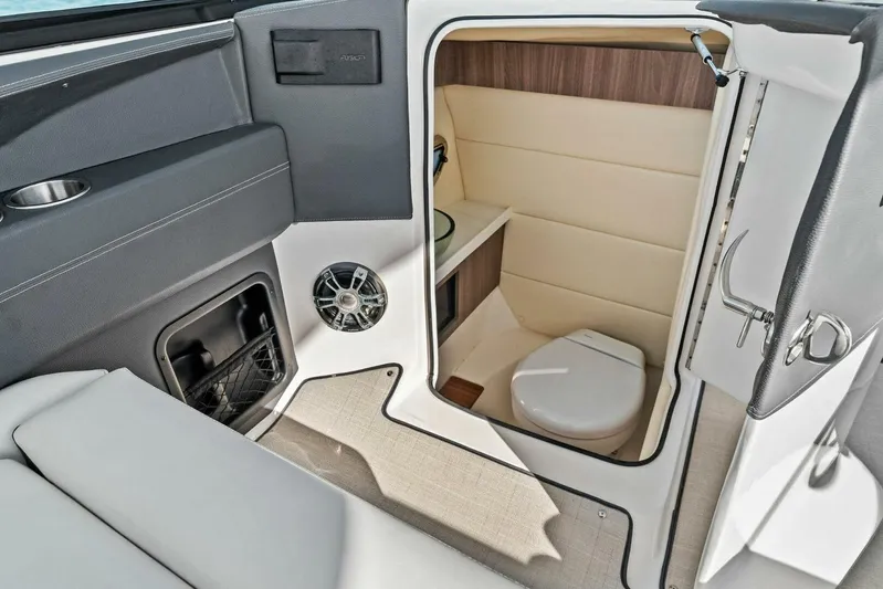  Yacht Photos Pics 2023 Regal 29 OBX boat interior with compact bathroom and modern amenities.