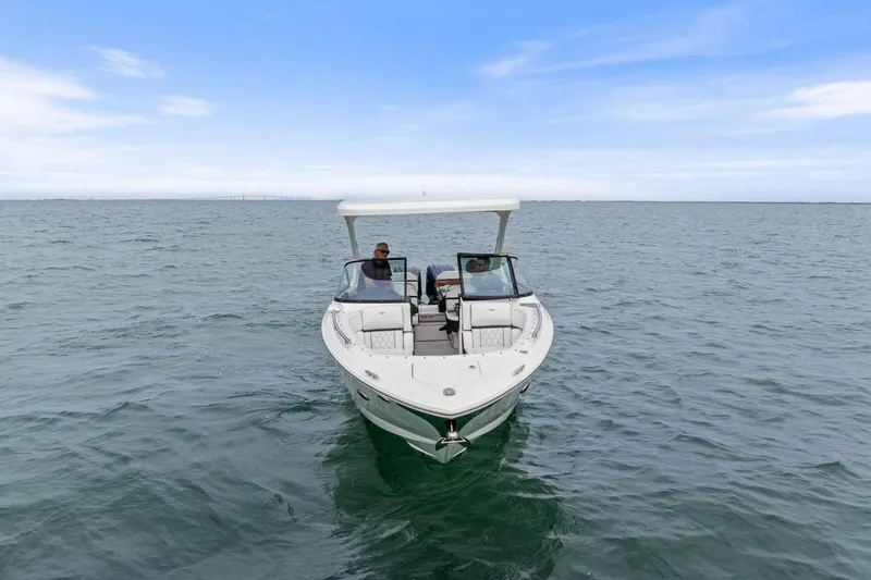  Yacht Photos Pics 2023 Regal 29 OBX boat cruising on open water under a clear sky.