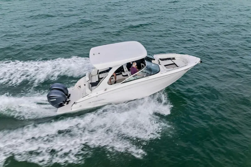  Yacht Photos Pics 2023 Regal 29 OBX boat cruising on open water, showcasing sleek design and powerful engines.