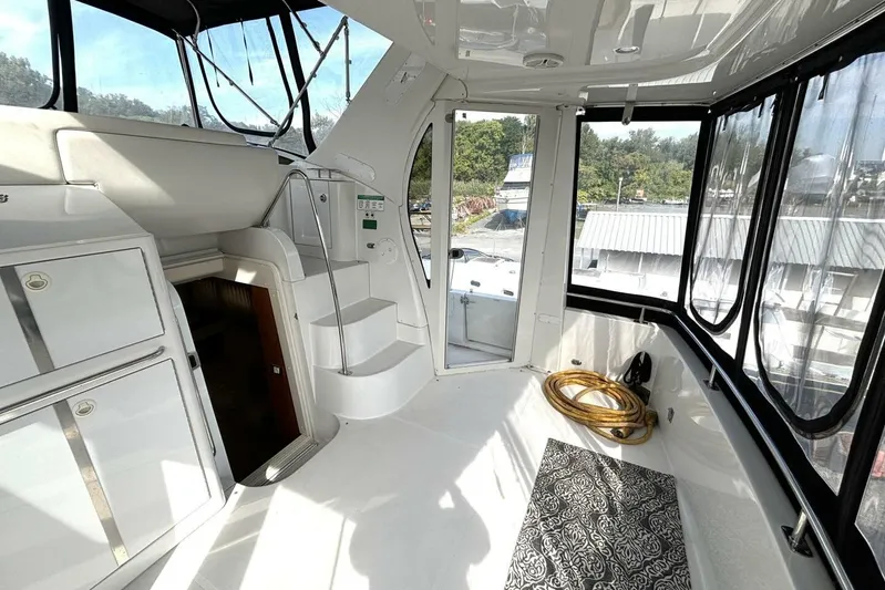  Yacht Photos Pics 2003 Carver 396 Motor Yacht interior with stairs, storage, and panoramic windows.