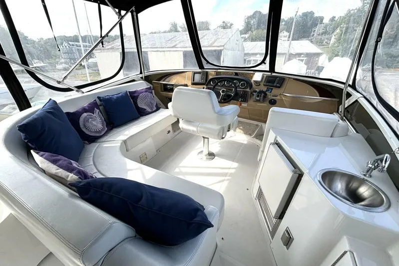  Yacht Photos Pics 2003 Carver 396 Motor Yacht interior with plush seating, helm, and kitchenette.