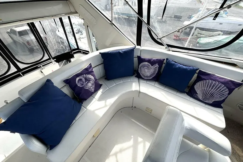  Yacht Photos Pics Luxurious 2003 Carver 396 Motor Yacht interior with blue and shell-themed cushions.