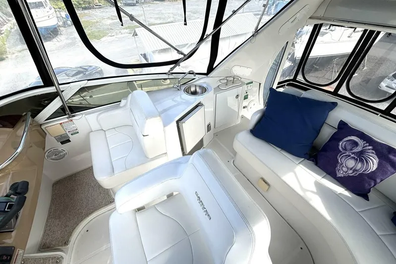  Yacht Photos Pics 2003 Carver 396 Motor Yacht interior with white seating and blue cushions.