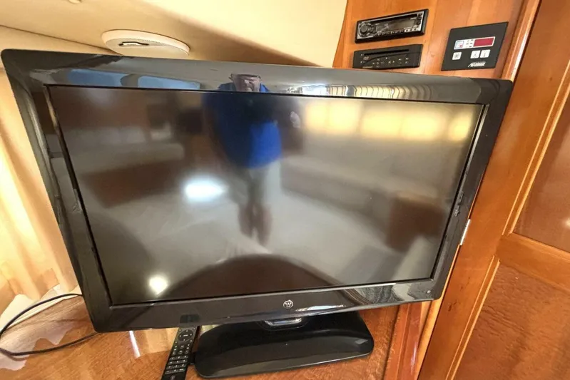  Yacht Photos Pics Flat-screen TV inside 2003 Carver 396 Motor Yacht, with remote and control panel.