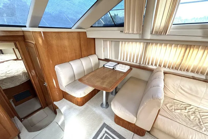 Yacht Photos Pics Luxurious interior of 2003 Carver 396 Motor Yacht with plush seating and wooden accents.