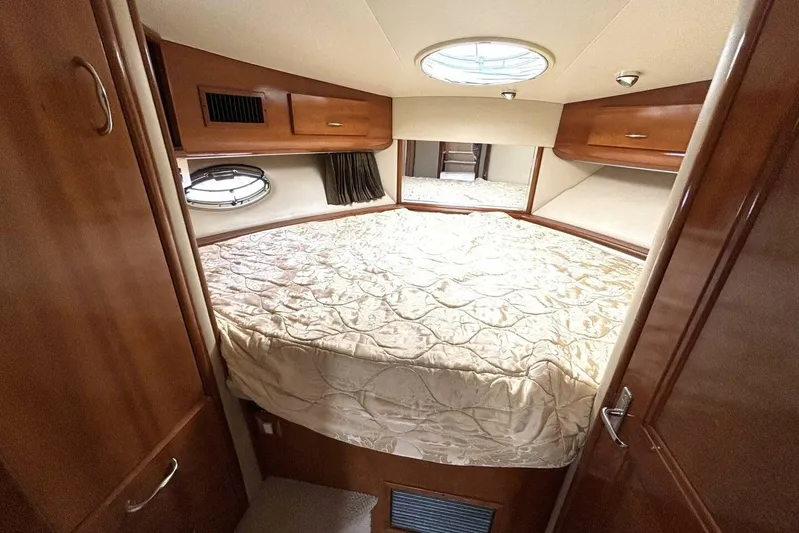  Yacht Photos Pics 2003 Carver 396 Motor Yacht bedroom with cozy bed and wooden cabinetry.