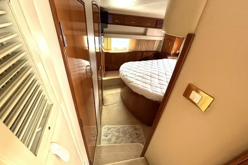  Yacht Photos Pics Interior of 2003 Carver 396 Motor Yacht with cozy bedroom and wooden finishes.