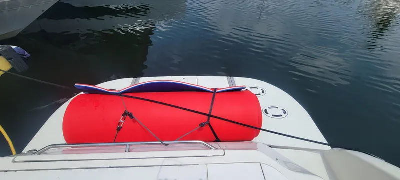  Yacht Photos Pics 2004 Sea Ray 480 Sedan Bridge with red inflatable tube on swim platform.