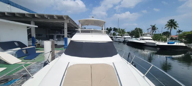 Yacht Photos Pics 2004 Sea Ray 480 Sedan Bridge yacht docked at a marina with other boats.