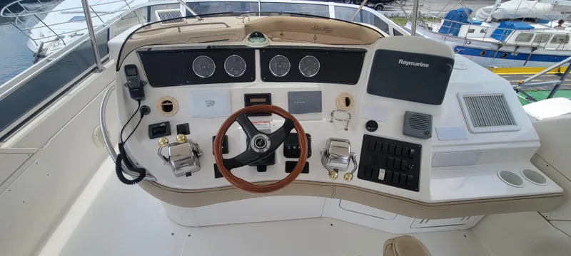  Yacht Photos Pics 2004 Sea Ray 480 Sedan Bridge helm with steering wheel and navigation controls.