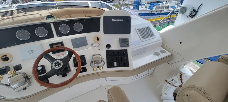  Yacht Photos Pics 2004 Sea Ray 480 Sedan Bridge helm with steering wheel and navigation controls.