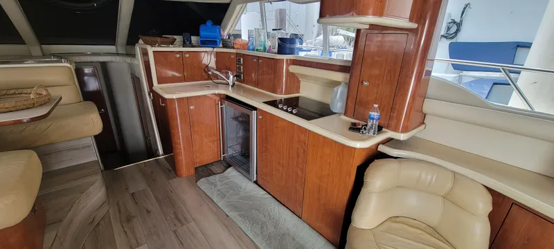  Yacht Photos Pics Interior of 2004 Sea Ray 480 Sedan Bridge yacht with kitchen and seating area.