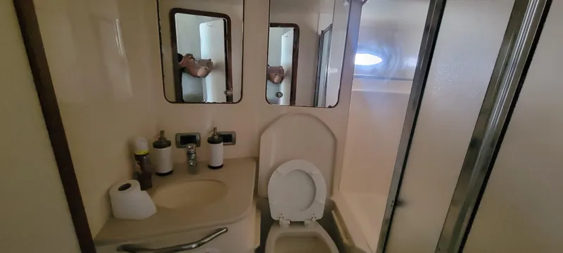  Yacht Photos Pics 2004 Sea Ray 480 Sedan Bridge bathroom with toilet, sink, mirrors, and shower.