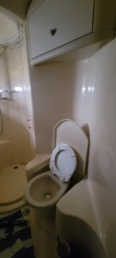  Yacht Photos Pics 2004 Sea Ray 480 Sedan Bridge bathroom with toilet and storage cabinet.