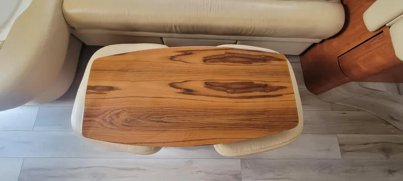  Yacht Photos Pics Wooden table in the interior of a 2004 Sea Ray 480 Sedan Bridge yacht.