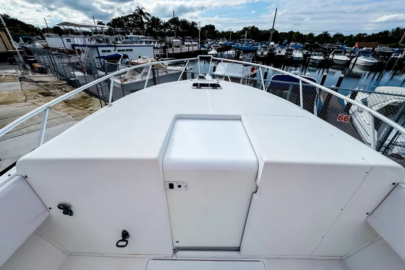  Yacht Photos Pics 2004 SeaVee 340i Cuddy boat deck at marina, surrounded by other boats.