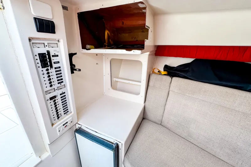  Yacht Photos Pics 2004 SeaVee 340i Cuddy interior with control panel, storage, and seating area.