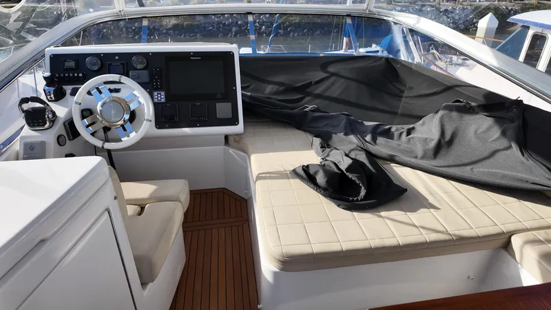 Yacht Photos Pics 2015 Azimut 54 Flybridge helm with modern controls and cushioned seating.