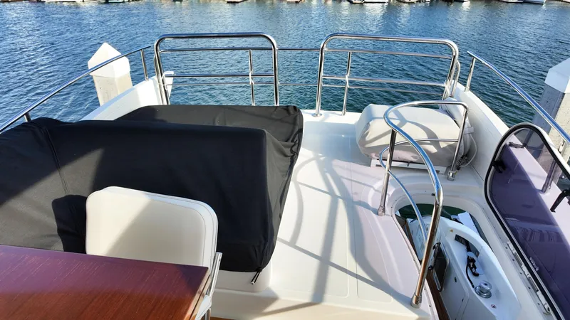  Yacht Photos Pics Flybridge of 2015 Azimut 54 Fly yacht with seating and railing, overlooking water.