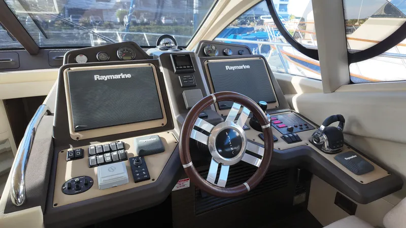  Yacht Photos Pics Cockpit of 2015 Azimut 54 Fly yacht with Raymarine navigation systems and steering wheel.