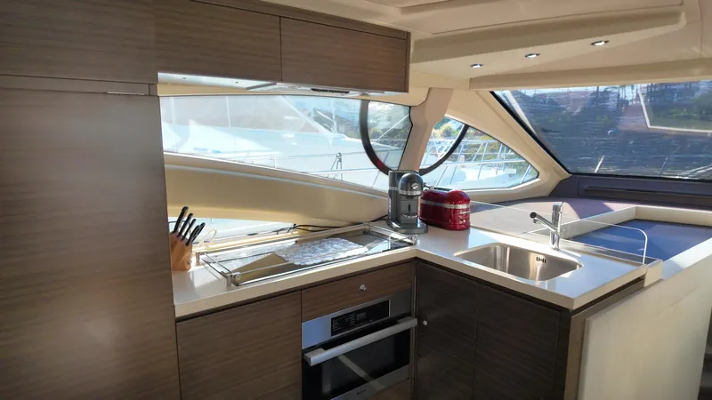 Yacht Photos Pics Luxurious kitchen interior of 2015 Azimut 54 Fly yacht with modern appliances and sleek design.