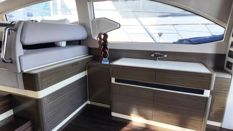  Yacht Photos Pics Luxurious interior of 2015 Azimut 54 Fly yacht with modern wood cabinetry and seating.