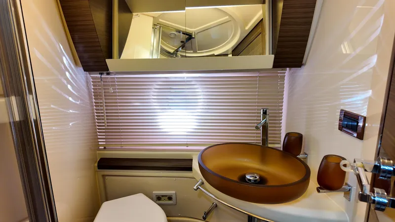  Yacht Photos Pics Luxurious bathroom interior of 2015 Azimut 54 Fly yacht with modern sink and fixtures.
