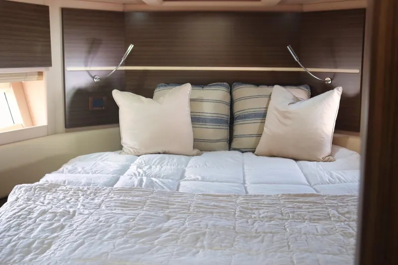  Yacht Photos Pics Luxurious bedroom interior of 2015 Azimut 54 Fly yacht with plush bedding.