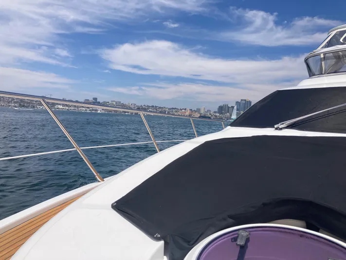  Yacht Photos Pics 2015 Azimut 54 Fly yacht cruising on open water with city skyline in background.