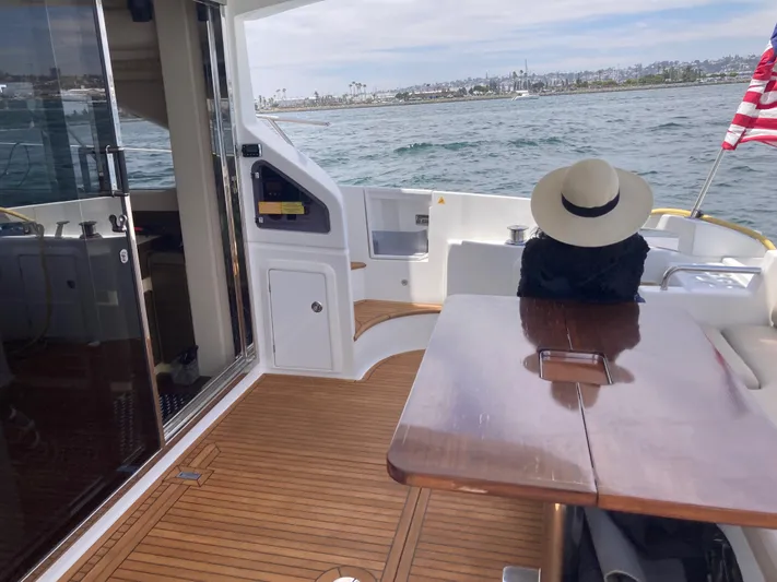  Yacht Photos Pics Azimut 54 Fly 2015 yacht deck with person in hat, ocean view, and American flag.