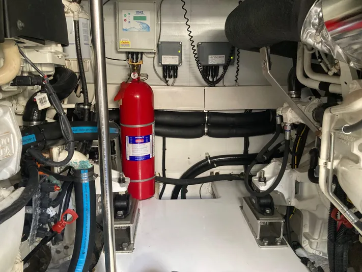  Yacht Photos Pics Engine room of 2015 Azimut 54 Fly yacht, featuring fire extinguisher and mechanical components.