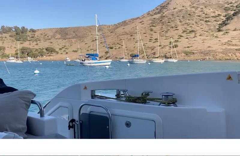  Yacht Photos Pics Azimut 54 Fly yacht in serene bay with sailboats and hills, 2015 model.