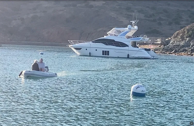 Yacht Photos Pics 2015 Azimut 54 Fly yacht anchored in serene bay with small boat nearby.