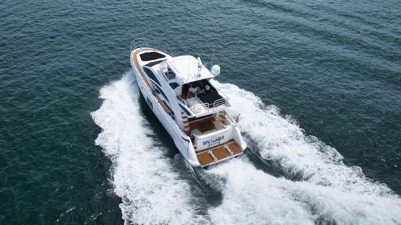  Yacht Photos Pics Azimut 54 Fly 2015 yacht cruising on open water, aerial view.