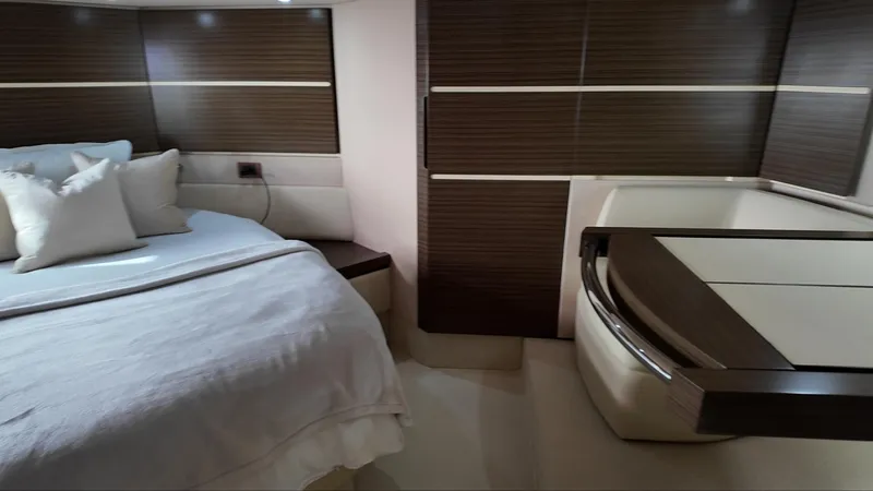  Yacht Photos Pics Luxurious bedroom interior of 2015 Azimut 54 Fly yacht with modern wood paneling.
