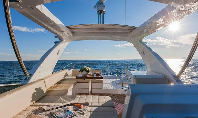  Yacht Photos Pics Luxurious 2015 Azimut 54 Fly yacht interior with ocean view and sunlit seating area.