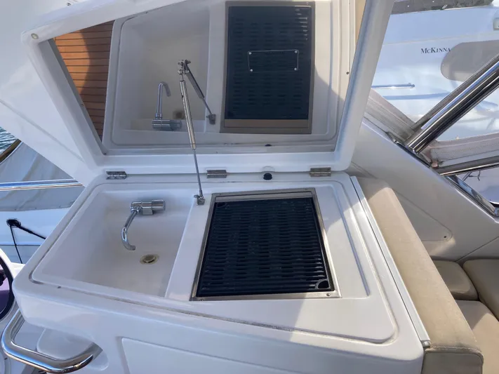  Yacht Photos Pics Outdoor kitchenette on a 2015 Azimut 54 Fly yacht with sink and grill.