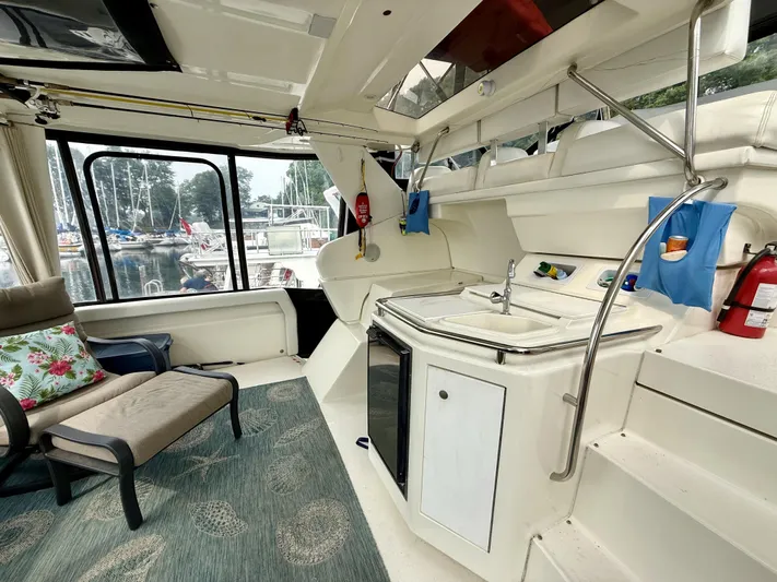  Yacht Photos Pics 1997 Silverton 402 Motor Yacht interior with kitchenette, seating, and marina view.
