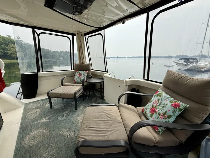  Yacht Photos Pics 1997 Silverton 402 Motor Yacht interior with cozy seating and scenic water view.