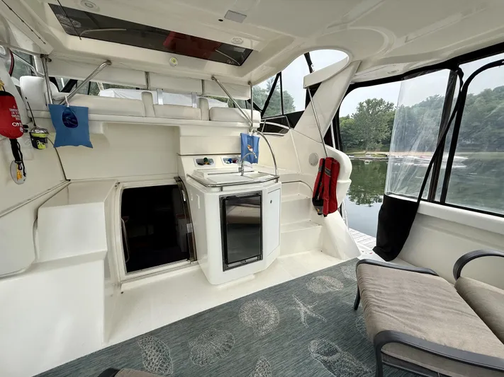  Yacht Photos Pics 1997 Silverton 402 Motor Yacht interior with kitchenette, seating, and lake view.