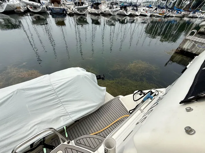  Yacht Photos Pics 1997 Silverton 402 Motor Yacht docked at marina with covered boat nearby.