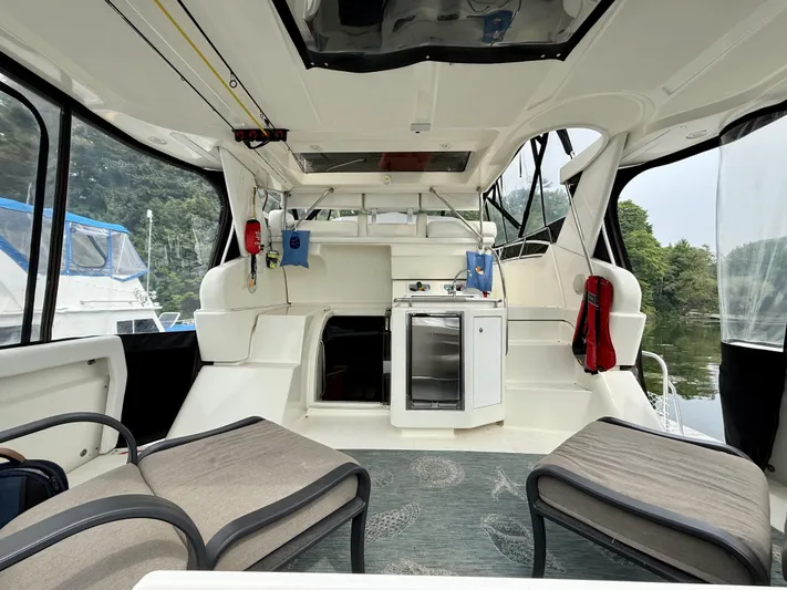  Yacht Photos Pics 1997 Silverton 402 Motor Yacht interior with seating, kitchenette, and scenic view.