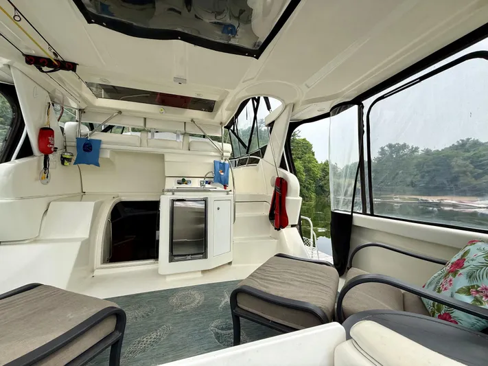  Yacht Photos Pics 1997 Silverton 402 Motor Yacht interior with seating, kitchenette, and scenic water view.