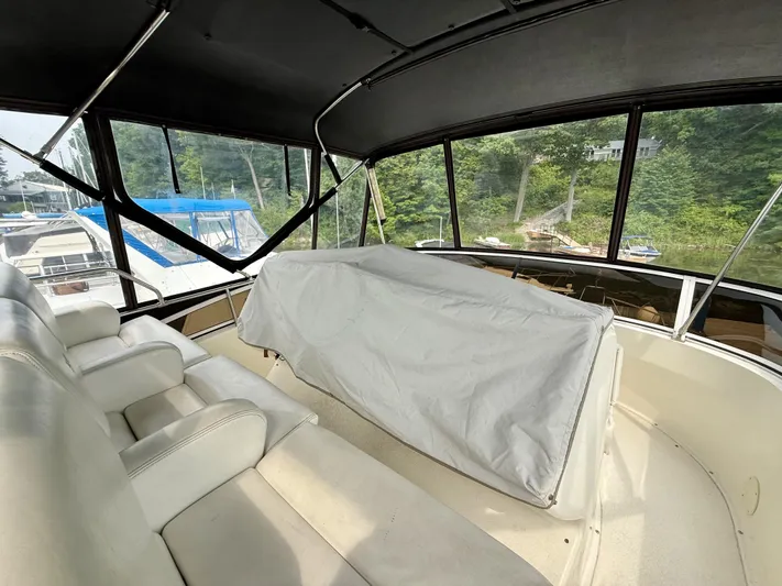  Yacht Photos Pics 1997 Silverton 402 Motor Yacht interior with covered seating and scenic marina view.