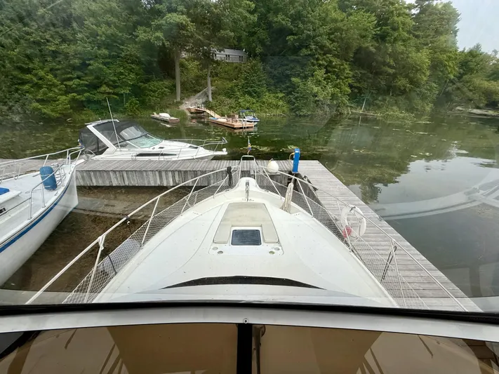  Yacht Photos Pics 1997 Silverton 402 Motor Yacht docked at a serene lakeside marina.